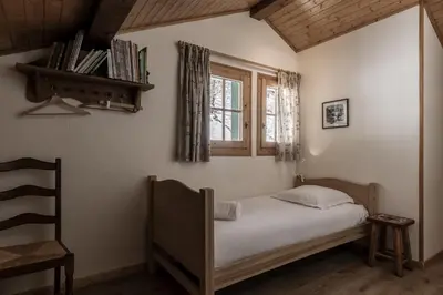 a small bedroom with a bed and a window at Chalet Marie Paradis vue Mont Blanc in Saint-Gervais-les-Bains