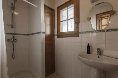 a bathroom with a sink and a shower and a mirror at Chalet Marie Paradis vue Mont Blanc in Saint-Gervais-les-Bains