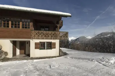 a house in the snow with a snow covered driveway at Chalet Marie Paradis vue Mont Blanc in Saint-Gervais-les-Bains