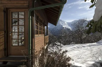 a door to a cabin with a view of a mountain at Chalet Marie Paradis vue Mont Blanc in Saint-Gervais-les-Bains