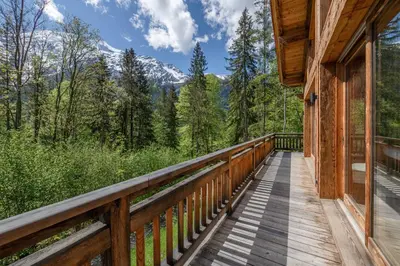 a deck with a view of the mountains at Chalet 1000 in Les Houches