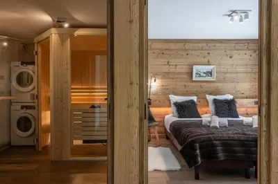a room with two beds and a washing machine at Chalet 1000 in Les Houches
