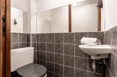 a bathroom with a toilet and a sink at La Poya Bas in Les Houches