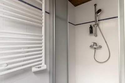 a shower in a bathroom with white walls at La Poya Bas in Les Houches