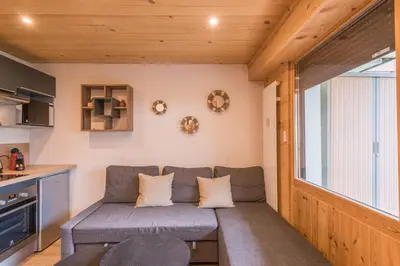 a living room with a couch and a table at Appartement Rothschild - garage - Welkeys in Megève