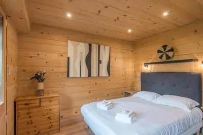 a bedroom with a bed in a wooden room at Appartement Rothschild - garage - Welkeys in Megève