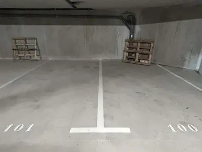 an empty parking lot with two pallets in it at Appartement 3 pièces, 4/6 couchages à Combloux avec parking - FR-1-597-178 in Combloux