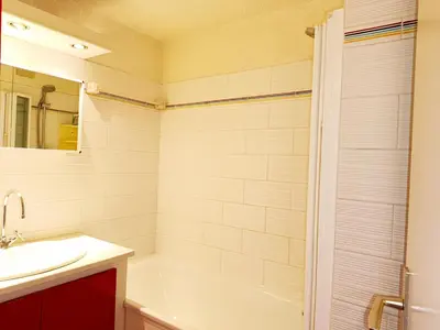 a bathroom with a white tub and a sink at Le Tavaillon in Saint-Gervais-les-Bains