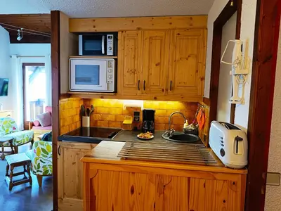 a kitchen with a sink and a microwave at Le Tavaillon in Saint-Gervais-les-Bains