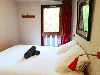 a bedroom with a bed with a pair of socks on it at Le Tavaillon in Saint-Gervais-les-Bains