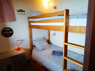 a bedroom with two bunk beds and a desk at Le Tavaillon in Saint-Gervais-les-Bains