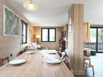 a dining room with a large wooden table and chairs at Chalet Le Splendide in Saint-Gervais-les-Bains