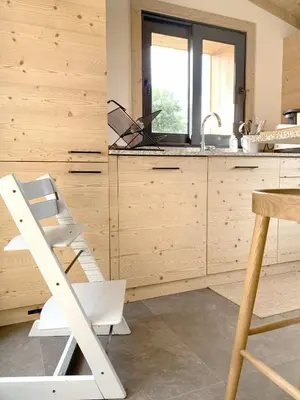 a kitchen with a white chair and a sink at Chalet Le Splendide in Saint-Gervais-les-Bains