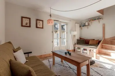 a living room with a couch and a table at Le Montagnard in Saint-Gervais-les-Bains