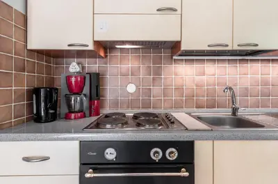 a kitchen with a stove and a sink at Le Montagnard in Saint-Gervais-les-Bains