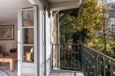 a balcony with a door and a table at Le Montagnard in Saint-Gervais-les-Bains