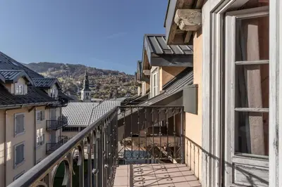 a balcony with a view of the city at Le Montagnard in Saint-Gervais-les-Bains