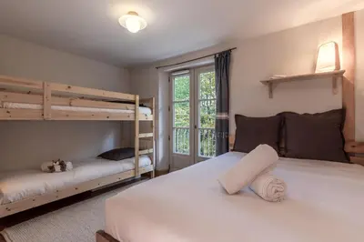 a bedroom with two bunk beds and a window at Le Montagnard in Saint-Gervais-les-Bains