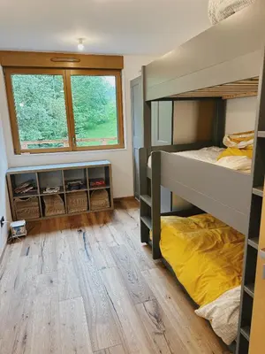 a bedroom with two bunk beds and a window at L'Olympe de Combloux - Terrasse & balcon sur la forêt in Combloux
