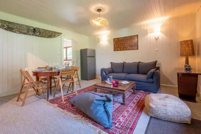 a living room with a blue couch and a table at Cocooning small chaming chalet with garden in Chamonix-Mont-Blanc