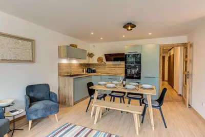 a kitchen and dining room with a table and chairs at Apartment Cristal des Glaces, Mont Blanc View, Alpes Travel, sleeps 6 in Chamonix-Mont-Blanc