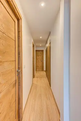a hallway with wooden floors and a door at Apartment Cristal des Glaces, Mont Blanc View, Alpes Travel, sleeps 6 in Chamonix-Mont-Blanc