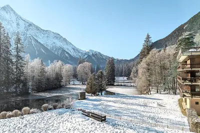 a view of a river in the snow with a mountain at Apartment Cristal des Glaces, Mont Blanc View, Alpes Travel, sleeps 6 in Chamonix-Mont-Blanc