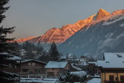 a town with snow covered buildings and mountains at Apartment Cristal des Glaces, Mont Blanc View, Alpes Travel, sleeps 6 in Chamonix-Mont-Blanc