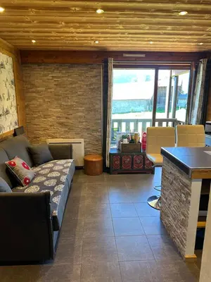 a living room with a couch and a table at standing 4 étoiles in Demi-Quartier