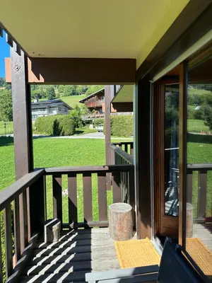 a screened porch with a view of a green field at standing 4 étoiles in Demi-Quartier