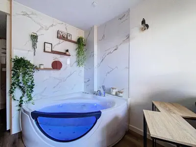 a bathroom with a large blue tub in a room at Le Cocon de Chamonix in Chamonix-Mont-Blanc