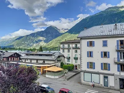 a city with buildings and mountains in the background at Le Cocon de Chamonix in Chamonix-Mont-Blanc