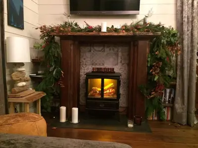 a fireplace in a living room with a fire in it at Heart of Chamonix Lovely and cosy 2 bedrooms, terrace, parking in Chamonix-Mont-Blanc