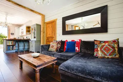a living room with a couch and a table at Heart of Chamonix Lovely and cosy 2 bedrooms, terrace, parking in Chamonix-Mont-Blanc