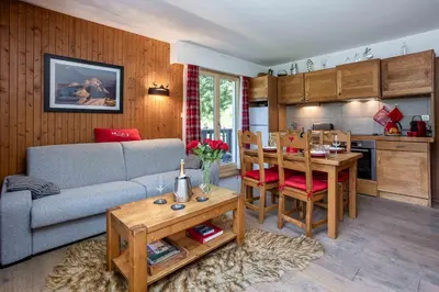 a living room with a couch and a table at Le Brevent 2 Apartment - Chamonix All Year in Chamonix-Mont-Blanc