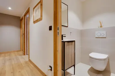 a bathroom with a toilet and a glass door at Chalet Ciscana Chamonix MontBlanc in Chamonix-Mont-Blanc