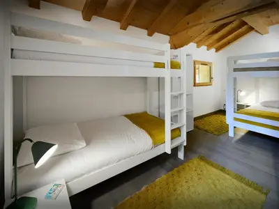 a bedroom with two bunk beds and a mirror at Chalet Morris - OVO Network in Sixt