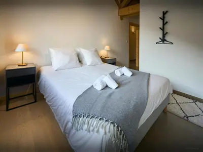 a bedroom with a bed with two towels on it at Chalet Morris - OVO Network in Sixt