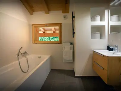 a bathroom with a tub and a sink at Chalet Morris - OVO Network in Sixt