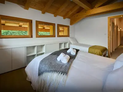 a bedroom with two beds with towels on it at Chalet Morris - OVO Network in Sixt