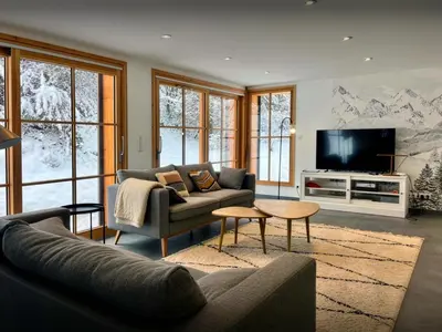a living room with a couch and a tv at Chalet Morris - OVO Network in Sixt