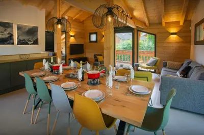 a dining room with a wooden table and chairs at MontCriou - OVO Network in Samoëns