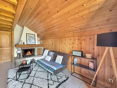 a living room with a couch and a fireplace at LUTB17 - Duplex 6 personnes au pied des pistes in Les Carroz d'Araches