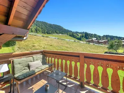 a balcony with a bench and a view of a field at LUTB17 - Duplex 6 personnes au pied des pistes in Les Carroz d'Araches