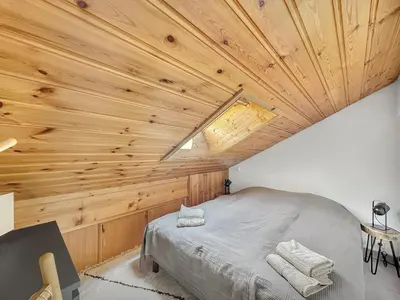 a bedroom with a wooden ceiling with a bed at LUTB17 - Duplex 6 personnes au pied des pistes in Les Carroz d'Araches