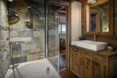 a bathroom with a tub and a sink and a shower at Chalet Vardache - OVO Network in Cordon