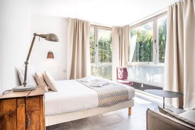 a bedroom with a bed and a large window at Appt Daisy - Familial - Calme - Vues in Chamonix-Mont-Blanc