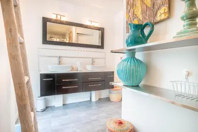 a bathroom with two sinks and a vase on a counter at Appt Daisy - Familial - Calme - Vues in Chamonix-Mont-Blanc