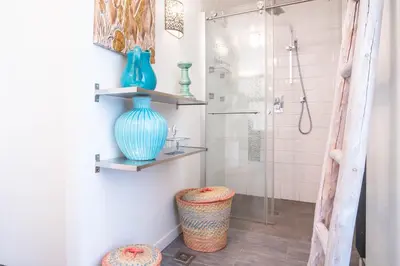 a bathroom with a blue vase and a shower at Appt Daisy - Familial - Calme - Vues in Chamonix-Mont-Blanc
