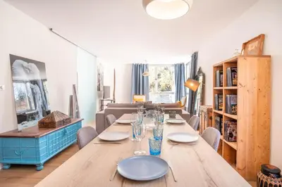 a dining room with a long wooden table and chairs at Appt Daisy - Familial - Calme - Vues in Chamonix-Mont-Blanc